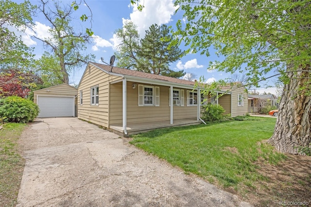 ranch-style house featuring a detached garage, an outbuilding, and a front lawn
