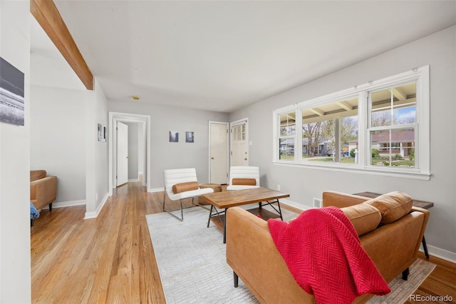 living area featuring light wood-type flooring and baseboards