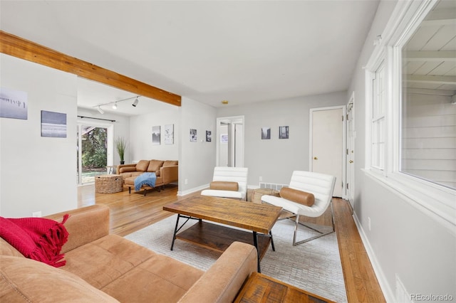 living area with wood finished floors and baseboards