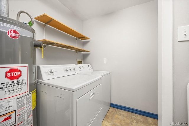laundry room with water heater, washer and dryer, and baseboards