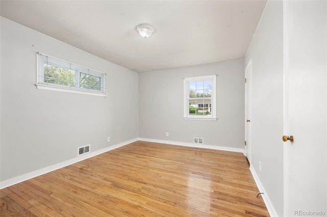 unfurnished room featuring light wood-style floors and baseboards