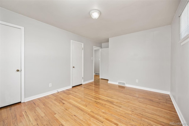 unfurnished bedroom featuring light wood finished floors and baseboards