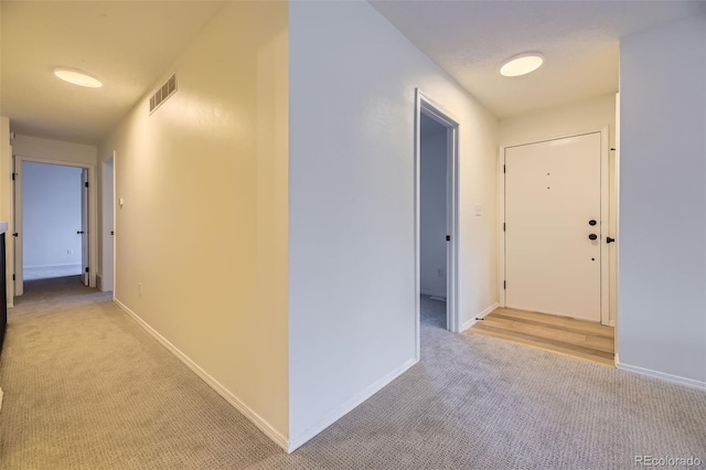 hallway featuring light carpet