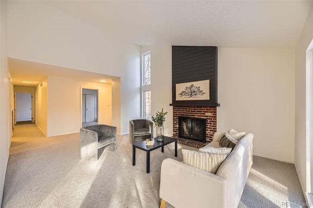 carpeted living room featuring high vaulted ceiling and a fireplace