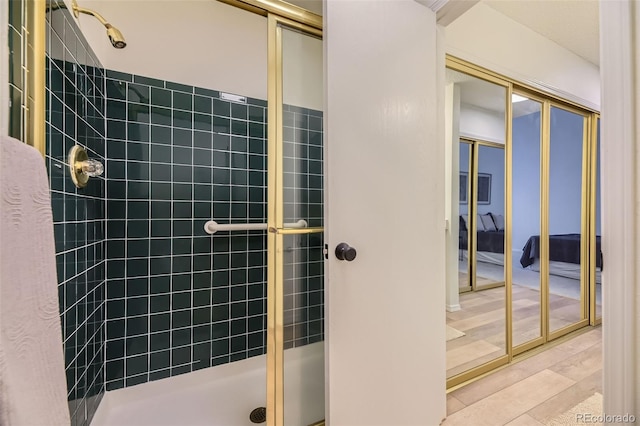 bathroom with walk in shower and hardwood / wood-style flooring