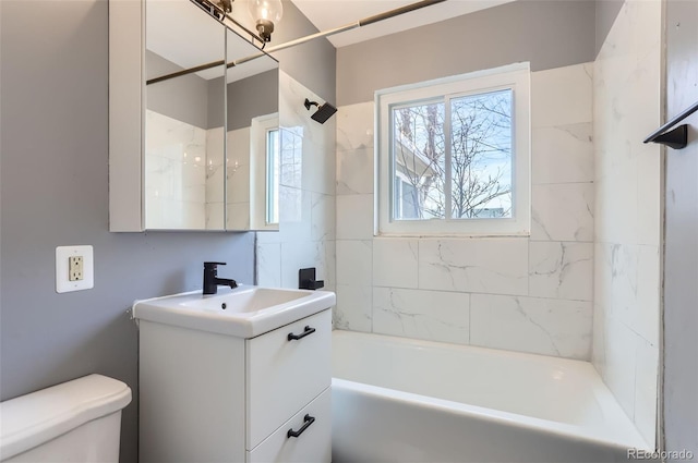 full bathroom featuring toilet, vanity, and bathing tub / shower combination