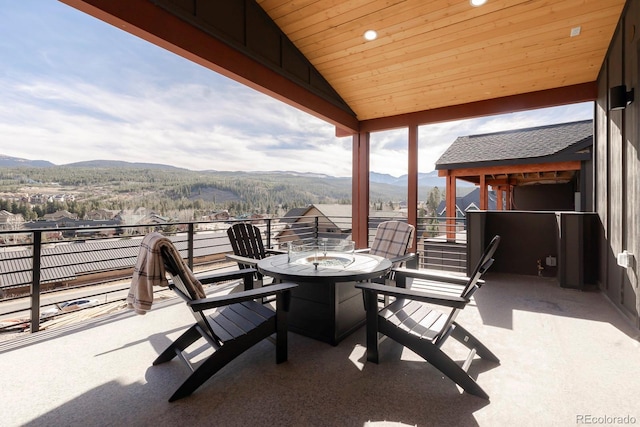 view of patio with a mountain view and a balcony