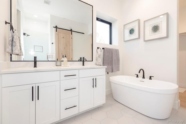 bathroom with a tub to relax in and vanity