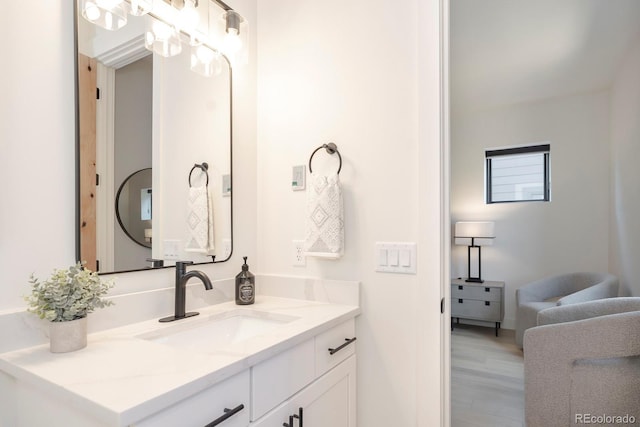 bathroom with hardwood / wood-style flooring and vanity