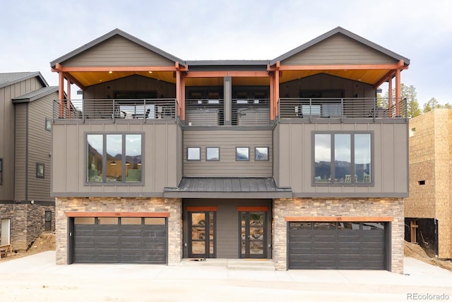 view of front of property with a garage and a balcony