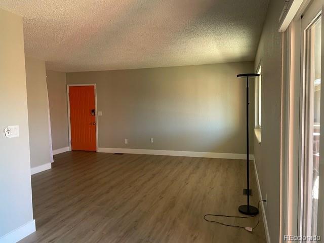 1415 Bacchus Dr Unit D9, Lafayette, CO 80026 - spare room featuring a textured ceiling and wood finished floors
