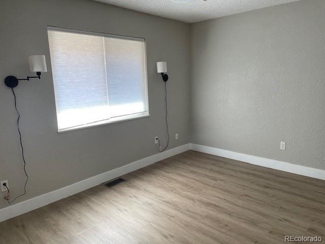 1415 Bacchus Dr Unit D9, Lafayette, CO 80026 - unfurnished room featuring wood finished floors and a textured ceiling