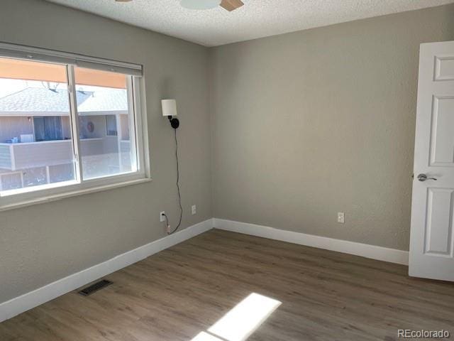 1415 Bacchus Dr Unit D9, Lafayette, CO 80026 - empty room featuring wood finished floors, ceiling fan, and a textured ceiling