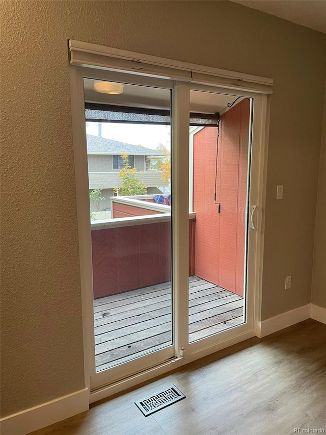1415 Bacchus Dr Unit D9, Lafayette, CO 80026 - doorway to outside with wood finished floors and a textured wall