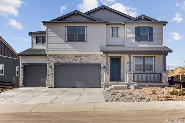 craftsman-style house with concrete driveway, a garage, covered porch, and stone siding