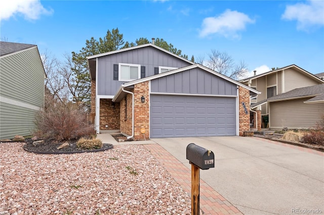 4028 S Atchison Way, Aurora, CO 80014 - view of front facade featuring board and batten siding, driveway, a garage, and brick siding
