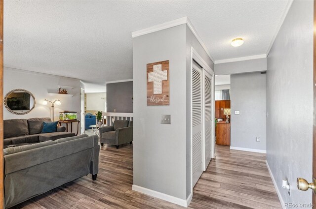 6735 E Lake Cir, Centennial, CO 80111 - hall featuring wood finished floors, a textured ceiling, crown molding, and baseboards