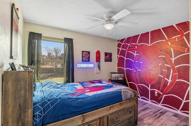 6735 E Lake Cir, Centennial, CO 80111 - bedroom featuring wood finished floors, a textured ceiling, and a ceiling fan