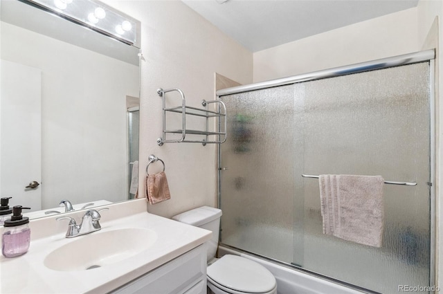 6735 E Lake Cir, Centennial, CO 80111 - full bathroom featuring bath / shower combo with glass door, toilet, and vanity
