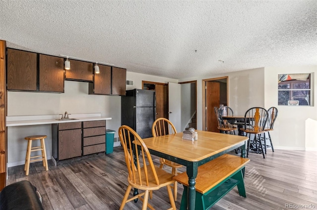 6735 E Lake Cir, Centennial, CO 80111 - dining room with baseboards, a textured ceiling, and dark wood-style floors