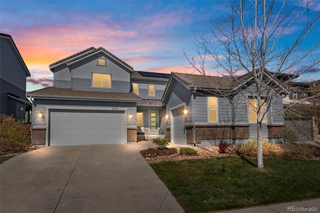 11023 Pastel Pt, Parker, CO 80134 - traditional-style home featuring brick siding, concrete driveway, an attached garage, a yard, and solar panels
