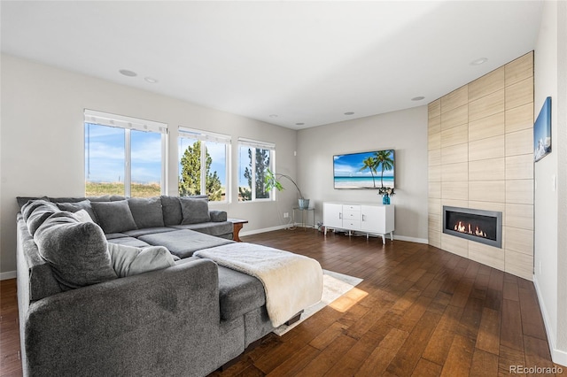 11023 Pastel Pt, Parker, CO 80134 - living room featuring recessed lighting, baseboards, dark wood finished floors, and a tile fireplace