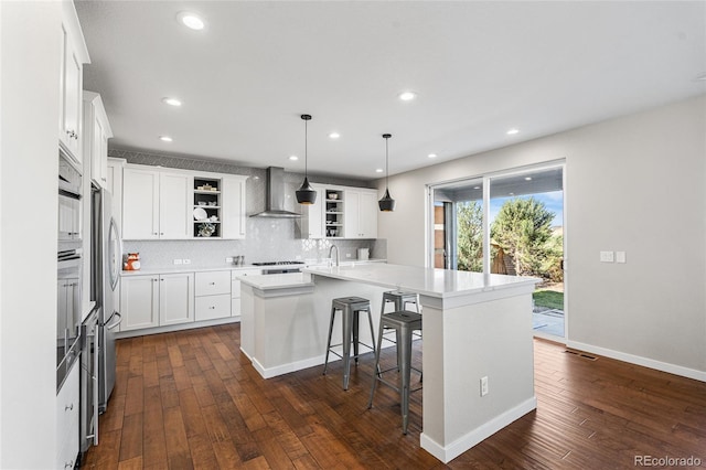 11023 Pastel Pt, Parker, CO 80134 - kitchen with open shelves, dark wood-style flooring, a kitchen island with sink, wall chimney range hood, and backsplash