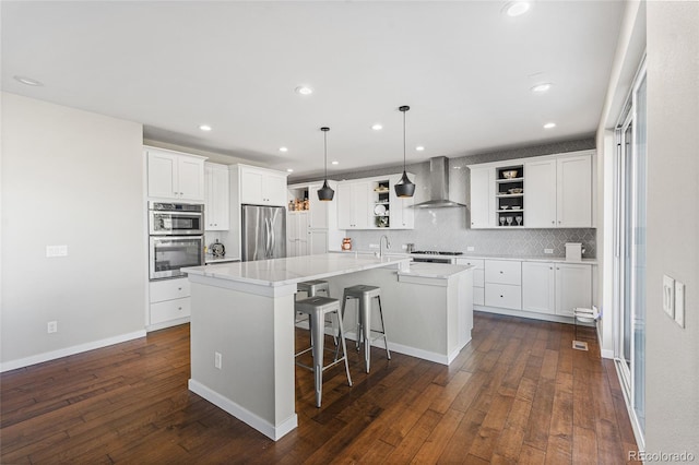 11023 Pastel Pt, Parker, CO 80134 - kitchen with open shelves, appliances with stainless steel finishes, wall chimney exhaust hood, a center island with sink, and dark wood-style floors