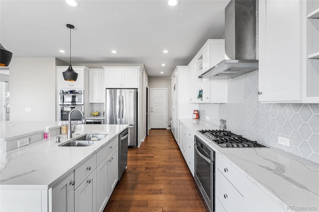 11023 Pastel Pt, Parker, CO 80134 - kitchen featuring wall chimney range hood, white cabinets, appliances with stainless steel finishes, a sink, and recessed lighting