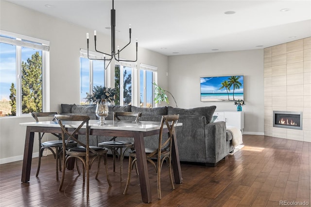 11023 Pastel Pt, Parker, CO 80134 - dining area with an inviting chandelier, dark wood finished floors, baseboards, and a wealth of natural light