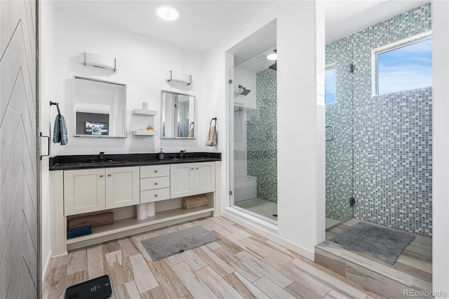 11023 Pastel Pt, Parker, CO 80134 - full bath with double vanity, a shower stall, a sink, and wood finished floors