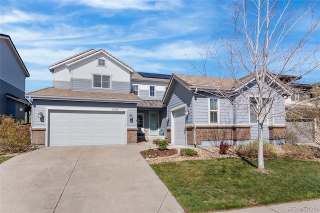 11023 Pastel Pt, Parker, CO 80134 - traditional-style home featuring an attached garage, a front lawn, brick siding, solar panels, and driveway