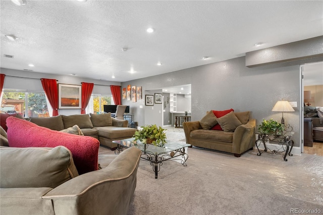 carpeted living room with a textured ceiling