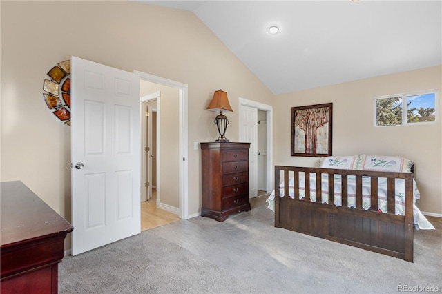 bedroom with light carpet and vaulted ceiling