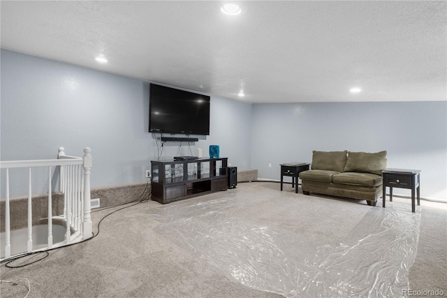 living room featuring carpet and a textured ceiling