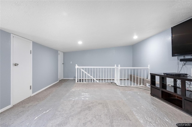 interior space featuring carpet and a textured ceiling