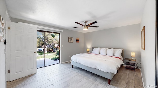 bedroom featuring access to exterior, ceiling fan, and light hardwood / wood-style floors