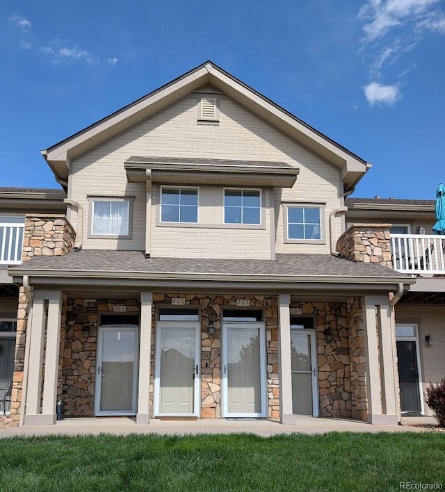 10818 Cimarron St Unit 206, Firestone, CO 80504 - back of property featuring stone siding and a porch