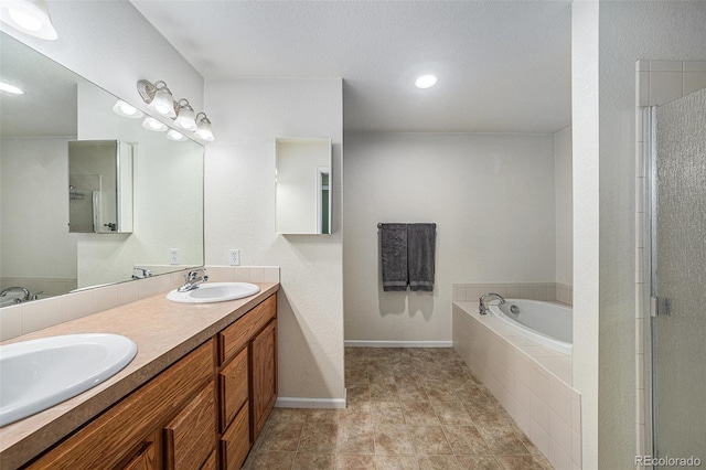10818 Cimarron St Unit 206, Firestone, CO 80504 - full bathroom featuring double vanity, a bath, baseboards, a shower with door, and recessed lighting
