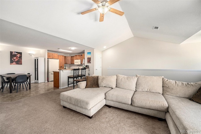 10818 Cimarron St Unit 206, Firestone, CO 80504 - living room featuring a ceiling fan, vaulted ceiling, light carpet, and recessed lighting
