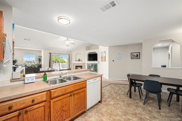 10818 Cimarron St Unit 206, Firestone, CO 80504 - kitchen with white dishwasher, a sink, a ceiling fan, open floor plan, and light countertops