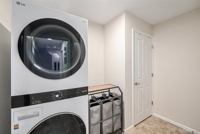 10818 Cimarron St Unit 206, Firestone, CO 80504 - laundry room with stacked washing machine and dryer and baseboards
