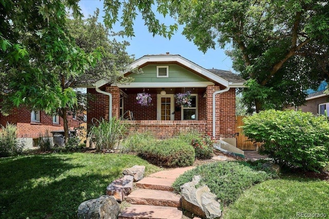 3622 Lowell Blvd, Denver, CO 80211 - view of front of home with brick siding, a front lawn, and covered porch