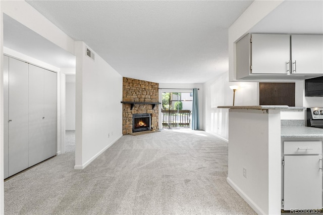 1758 S Pitkin Cir Unit A, Aurora, CO 80017 - unfurnished living room featuring light carpet and a fireplace