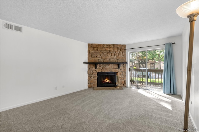1758 S Pitkin Cir Unit A, Aurora, CO 80017 - unfurnished living room featuring carpet floors, a textured ceiling, and a fireplace