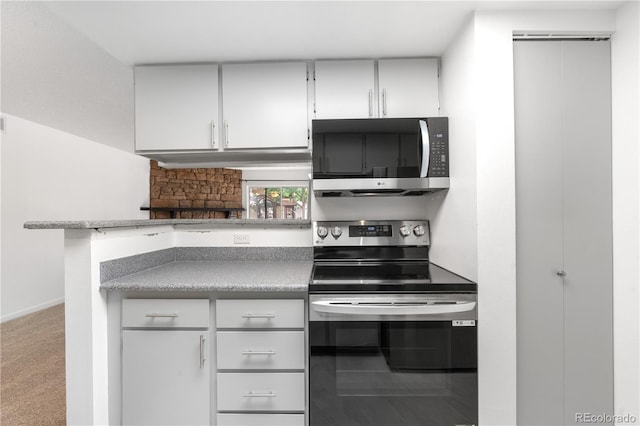 1758 S Pitkin Cir Unit A, Aurora, CO 80017 - kitchen featuring appliances with stainless steel finishes, white cabinetry, and carpet floors
