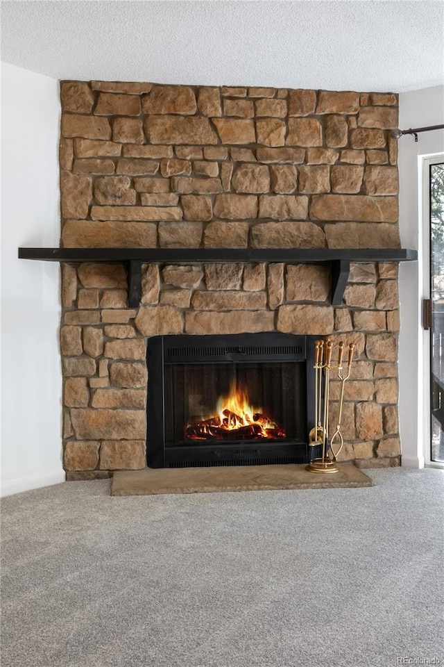 1758 S Pitkin Cir Unit A, Aurora, CO 80017 - detailed view of a stone fireplace, carpet floors, and a textured ceiling