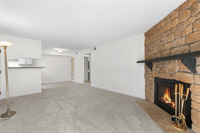 1758 S Pitkin Cir Unit A, Aurora, CO 80017 - unfurnished living room featuring a fireplace and light carpet