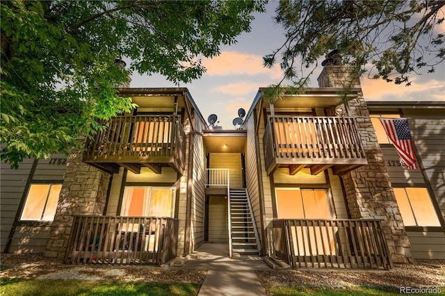 1758 S Pitkin Cir Unit A, Aurora, CO 80017 - view of front of home featuring a balcony, stone siding, and a chimney