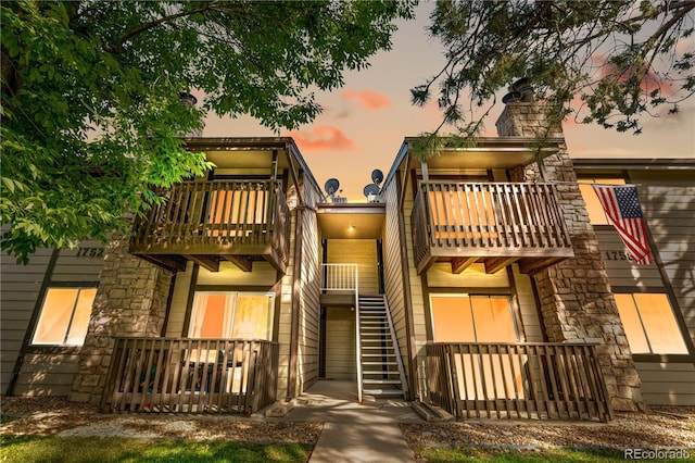 1758 S Pitkin Cir Unit A, Aurora, CO 80017 - view of front of property featuring a balcony, stone siding, and a chimney
